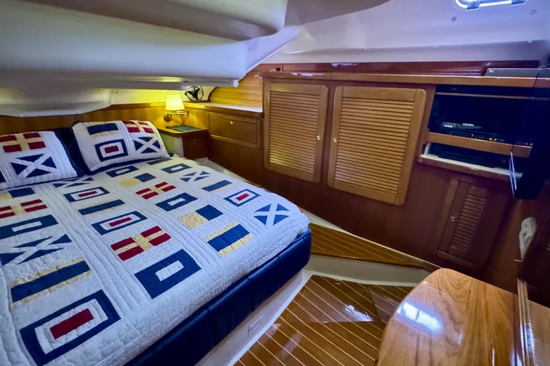 Slide: The Image of Luxurious cabin interior of 2005 Catalina 470 yacht with nautical-themed bedding. - 21