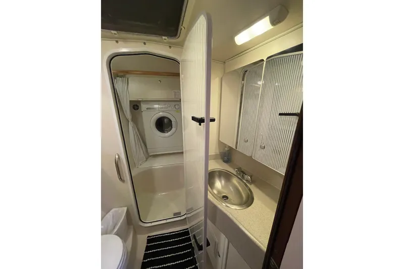 Slide: The Image of Compact bathroom with washer, sink, and storage in 2005 Catalina 470 yacht. - 27