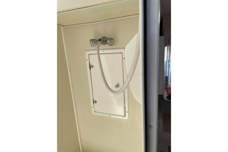 Slide: The Image of Shower area in 2005 Catalina 470 yacht, featuring a hose and control panel. - 29