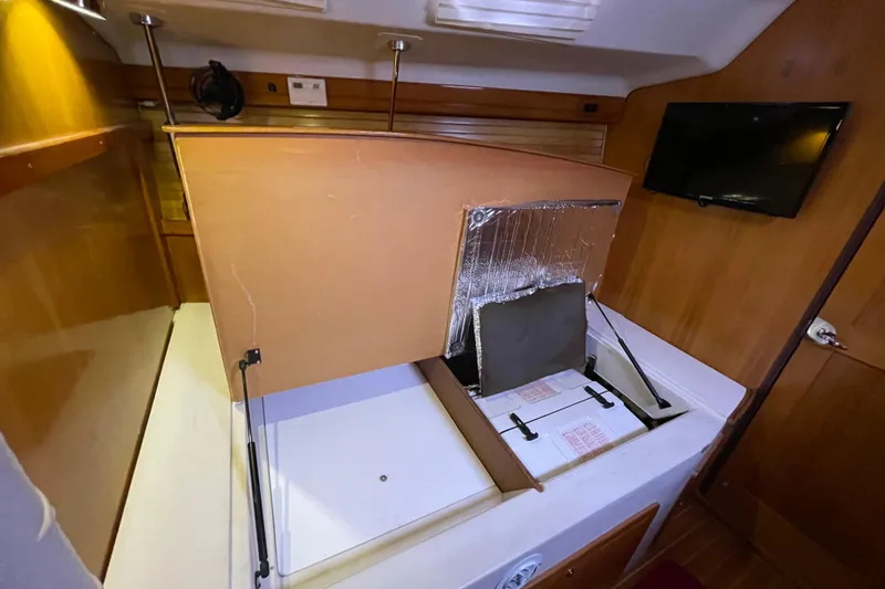 Slide: The Image of Interior of a 2005 Catalina 470 yacht with open storage compartment. - 32