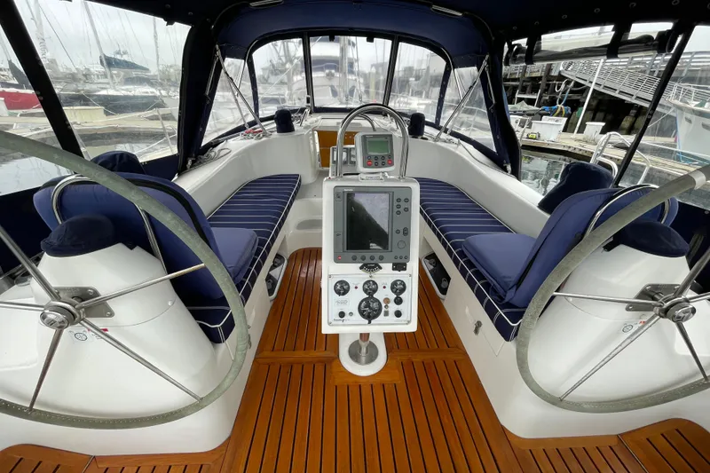 Slide: The Image of Cockpit of 2005 Catalina 470 sailboat with dual steering wheels and navigation equipment. - 4
