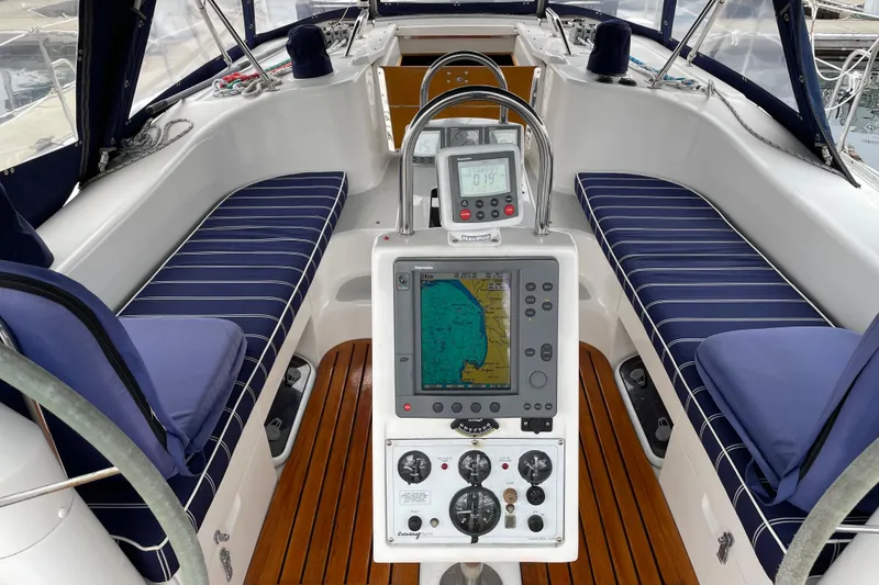 Slide: The Image of Cockpit of 2005 Catalina 470 sailboat with navigation equipment and cushioned seating. - 5