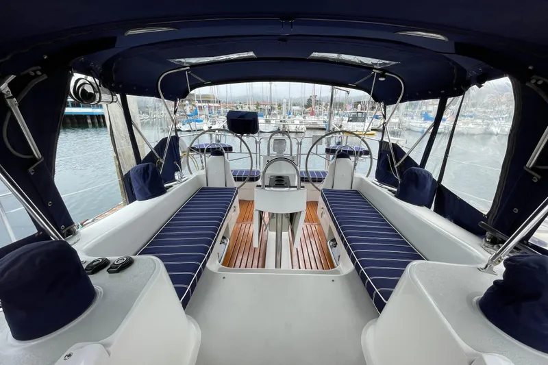 Slide: The Image of Interior view of a 2005 Catalina 470 sailboat cockpit with blue-striped seating. - 9