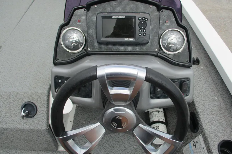 Slide: The Image of 2021 G3 Sportsman 1710 boat dashboard with steering wheel and navigation system. - 12