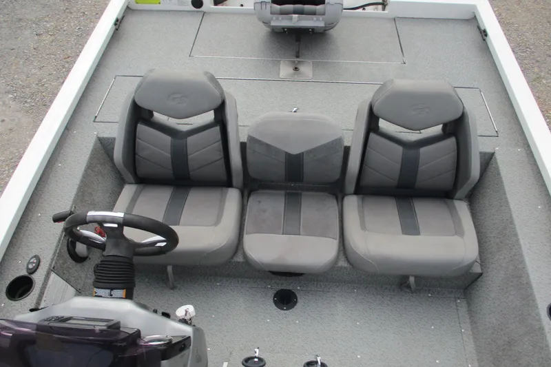 Slide: The Image of 2021 G3 Sportsman 1710 boat interior with three gray seats and steering console. - 9