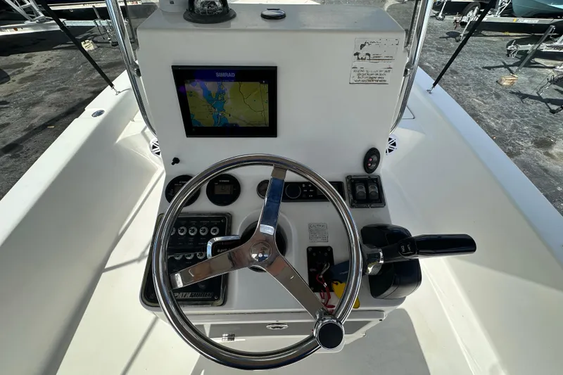Slide: The Image of Steering console of 2012 Pathfinder 2200 V boat with navigation display and controls. - 14
