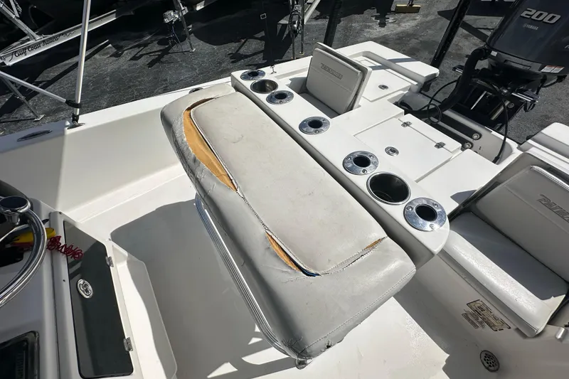 Slide: The Image of 2012 Pathfinder 2200 V boat interior with worn seating and multiple cup holders. - 16