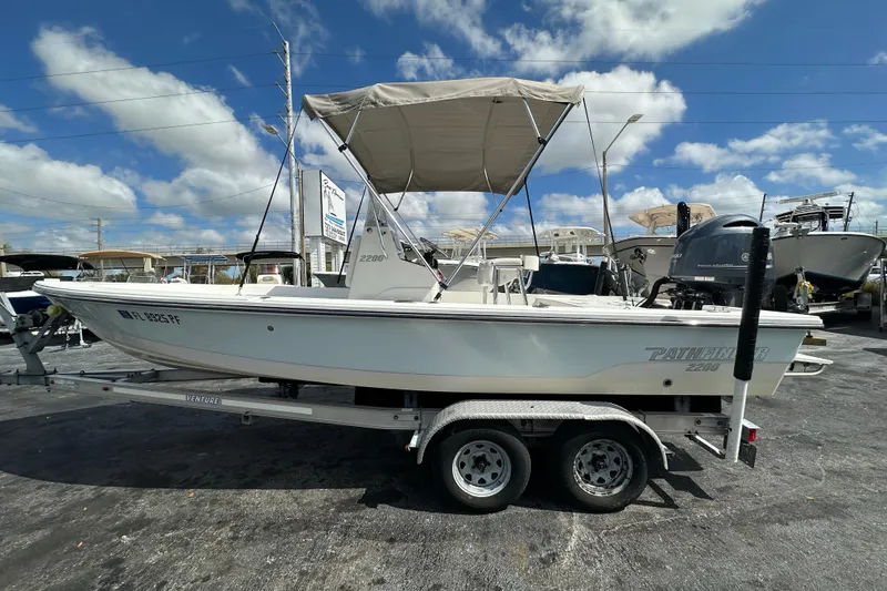 Slide: The Image of 2012 Pathfinder 2200 V boat on trailer under clear blue sky. - 2