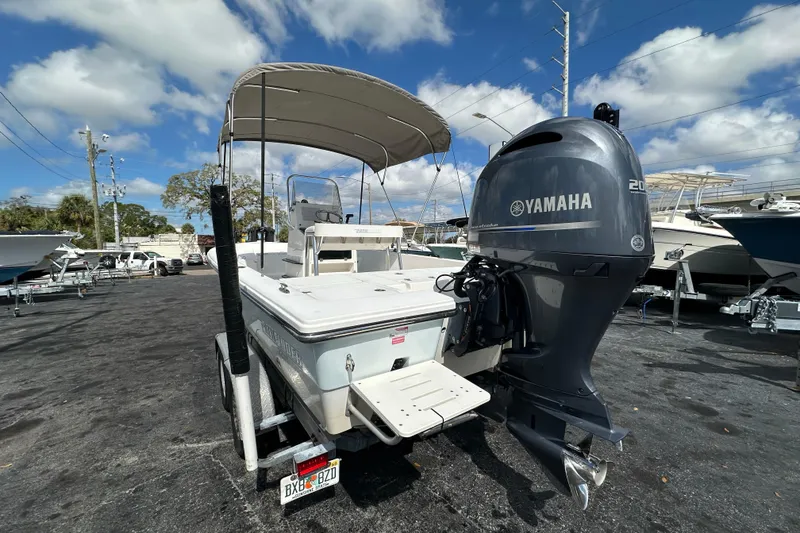 Slide: The Image of 2012 Pathfinder 2200 V boat with Yamaha outboard motor, parked under a clear blue sky. - 4