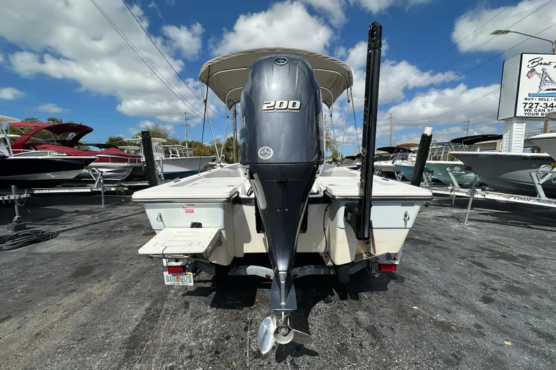 Slide: The Image of 2012 Pathfinder 2200 V boat with Yamaha 200 engine, parked outdoors under blue sky. - 5