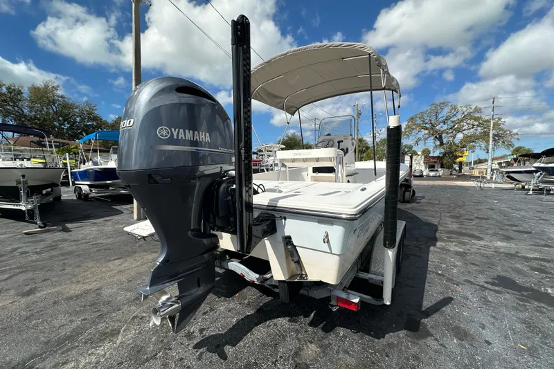 Slide: The Image of 2012 Pathfinder 2200 V boat with Yamaha engine, parked outdoors under a blue sky. - 6