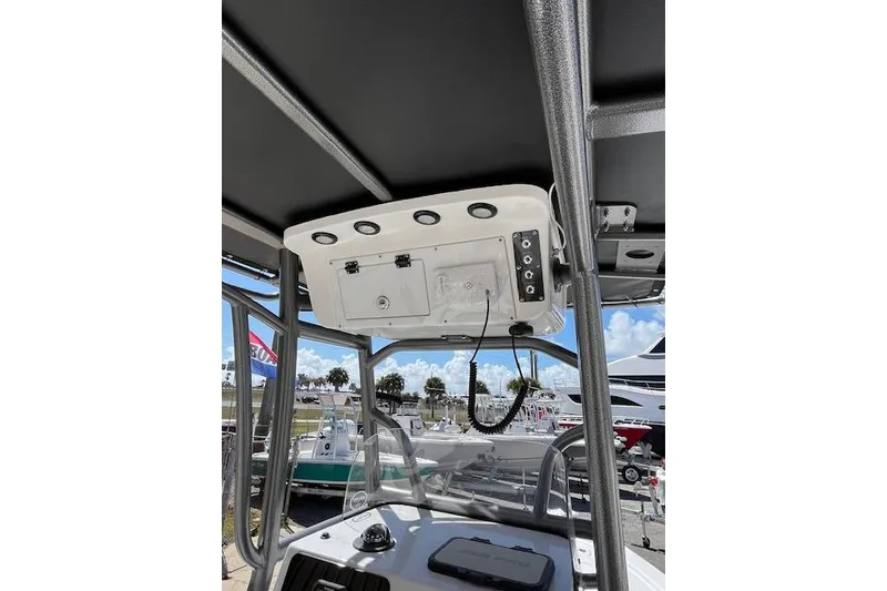 Slide: The Image of 2026 Sea Pro 210 Bay boat console with electronics and overhead storage. - 10