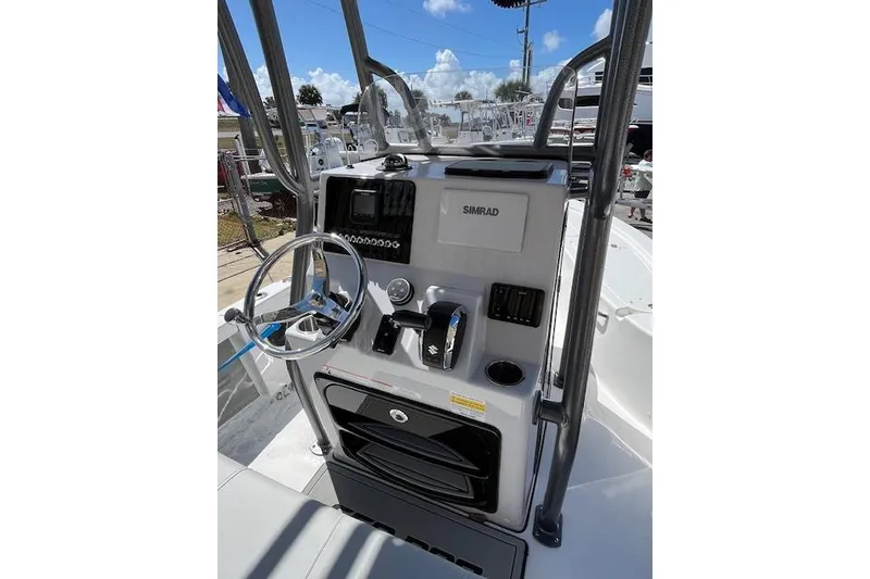 Slide: The Image of 2026 Sea Pro 210 Bay boat console with steering wheel and Simrad electronics. - 11