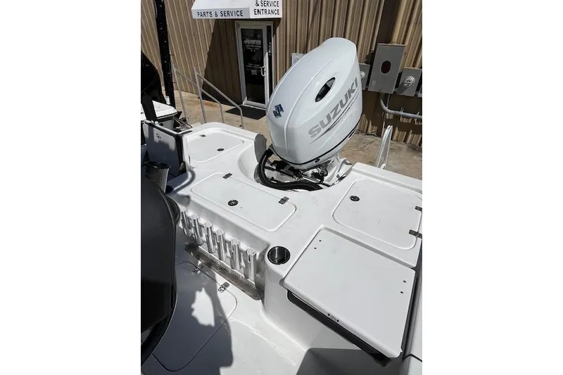 Slide: The Image of 2026 Sea Pro 210 Bay boat with Suzuki outboard motor at service entrance. - 12