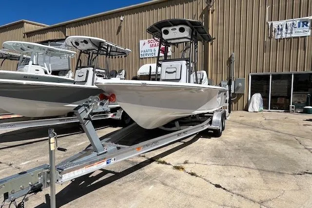 Slide: The Image of 2026 Sea Pro 210 Bay boat on trailer outside a marine service center. - 3