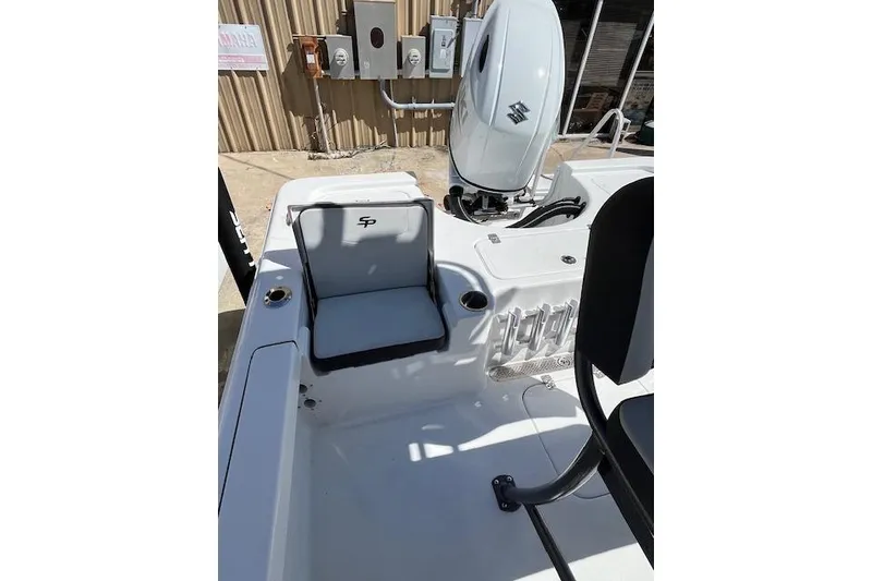 Slide: The Image of 2026 Sea Pro 210 Bay boat interior with seating and engine view. - 6
