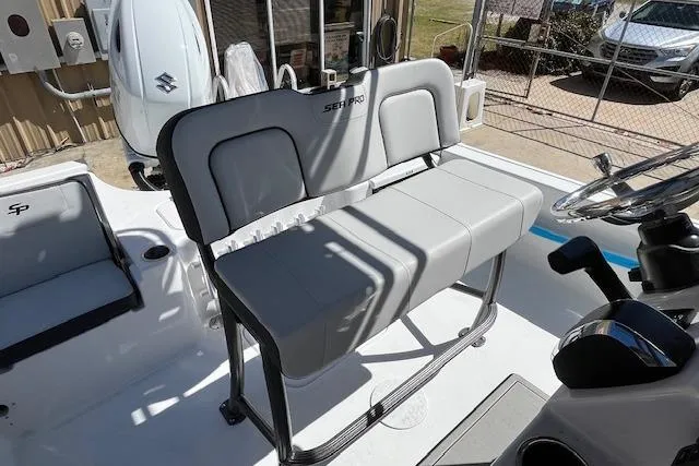 Slide: The Image of 2026 Sea Pro 210 Bay boat interior with gray seating and steering console. - 7