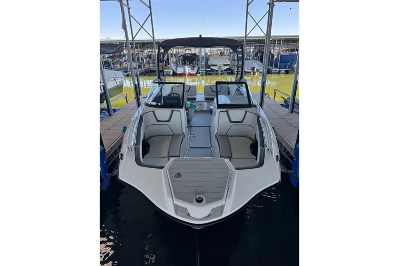 Slide: The Image of 2024 Yamaha Boats AR250 docked, showcasing sleek design and spacious seating. - 3