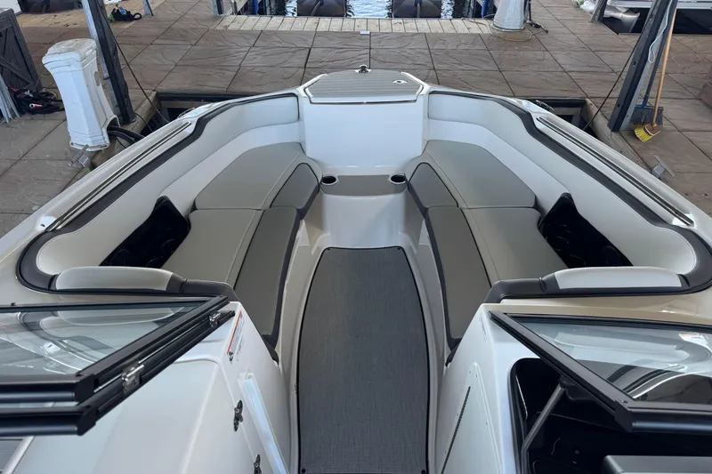 Slide: The Image of 2024 Yamaha Boats AR250 interior with spacious seating and modern design. - 6