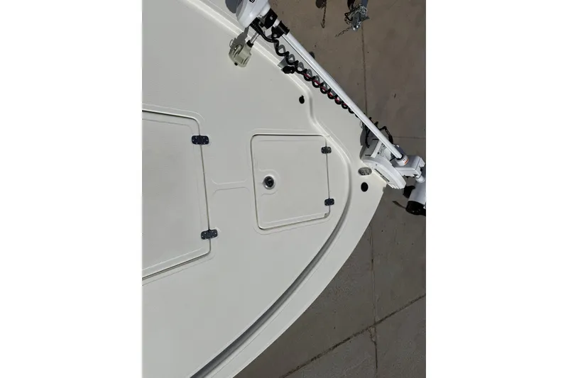 Slide: The Image of 2024 Mako 18 LTS boat deck with storage compartments and trolling motor. - 10