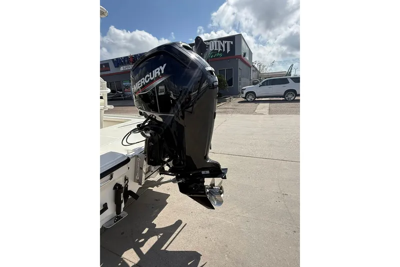 Slide: The Image of 2024 Mako 18 LTS boat with Mercury outboard motor in a dealership lot. - 12