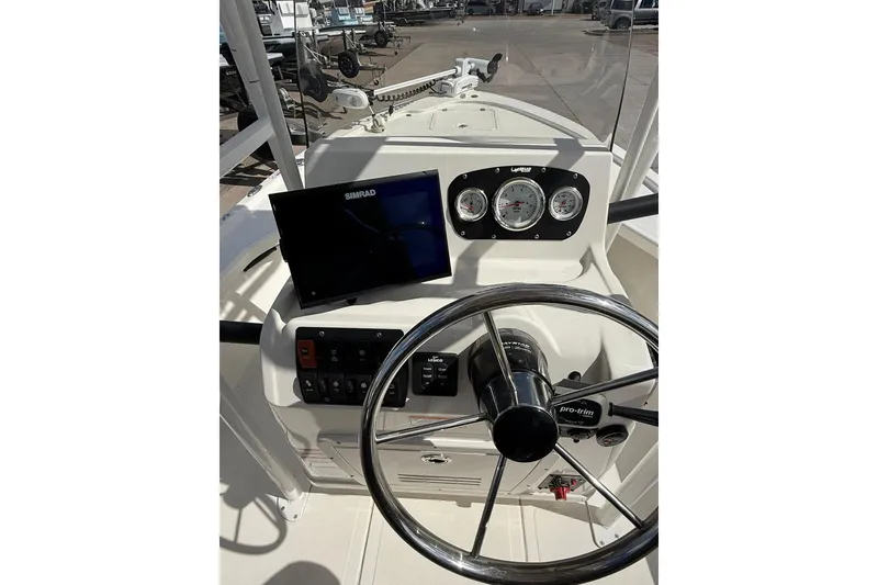 Slide: The Image of 2024 Mako 18 LTS boat dashboard with steering wheel and navigation display. - 3