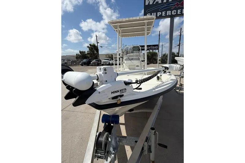 Slide: The Image of 2024 Mako 18 LTS boat with Minn Kota motor on display under clear sky. - 6