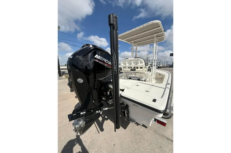 Slide: The Image of 2024 Mako 18 LTS boat with Mercury engine, rear view under clear sky. - 9