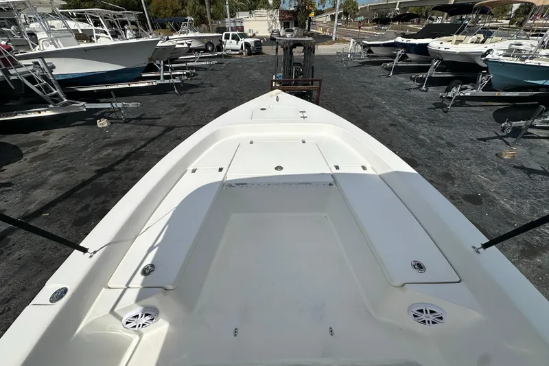 Slide: The Image of 2012 Pathfinder 2200 TRS boat on trailer, surrounded by other boats in a marina. - 12