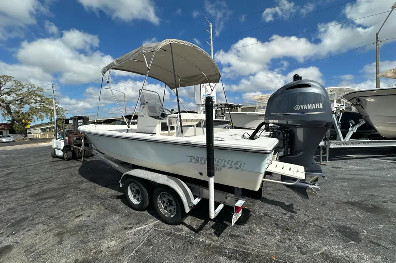 Slide: The Image of 2012 Pathfinder 2200 TRS boat with Yamaha outboard motor on trailer, under blue sky. - 3