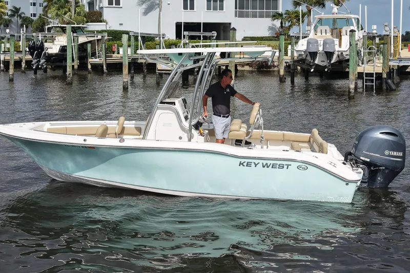 The Image of 2018 Key West 219 FS boat with Yamaha engine on water near docks. - 1