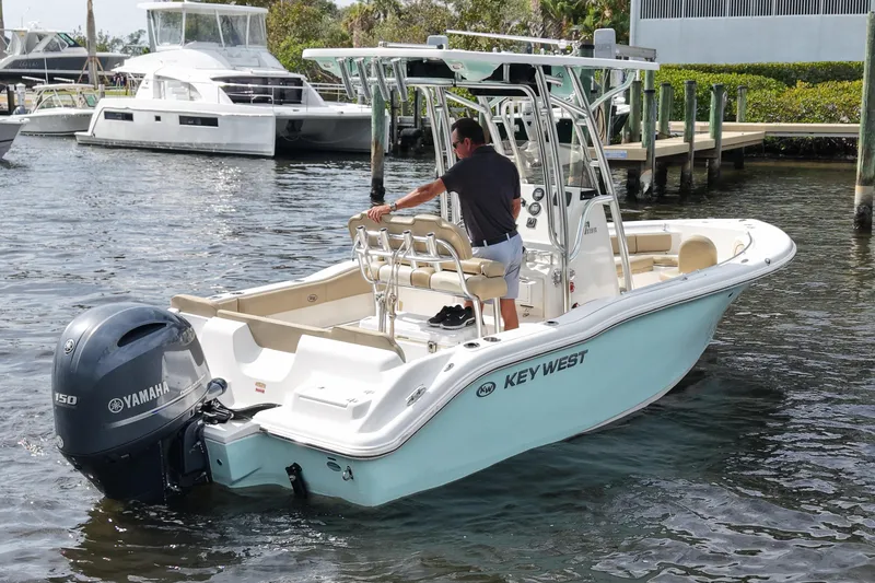 Slide: The Image of 2018 Key West 219 FS boat with Yamaha engine on water near dock. - 10