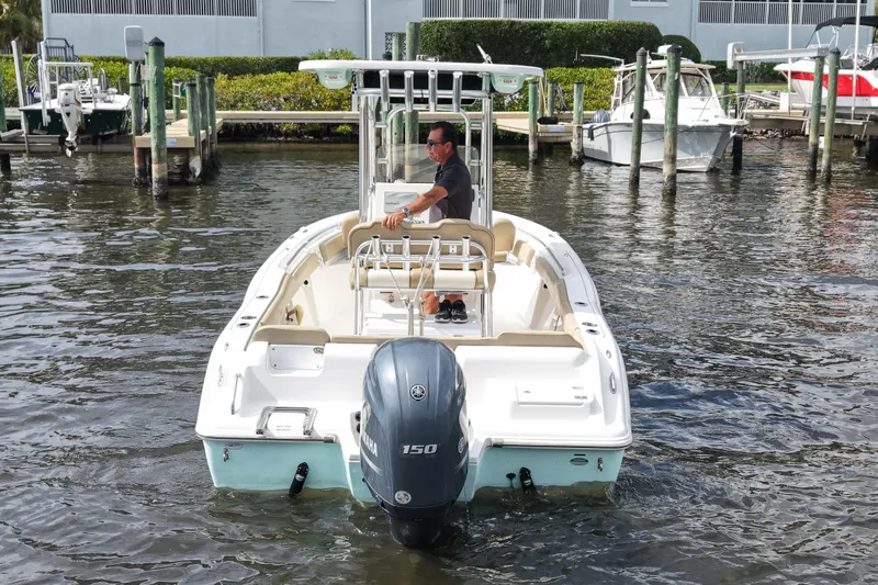 Slide: The Image of 2018 Key West 219 FS boat with Yamaha 150 engine on water near docks. - 11