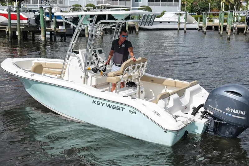 Slide: The Image of 2018 Key West 219 FS boat with Yamaha engine on water, docked in marina. - 12
