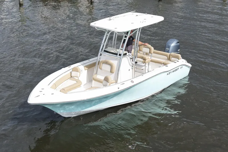 Slide: The Image of 2018 Key West 219 FS boat on water, featuring sleek design and comfortable seating. - 14