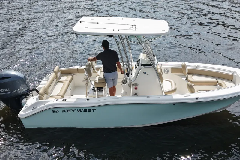 Slide: The Image of 2018 Key West 219 FS boat on water, featuring Yamaha engine and spacious seating. - 16