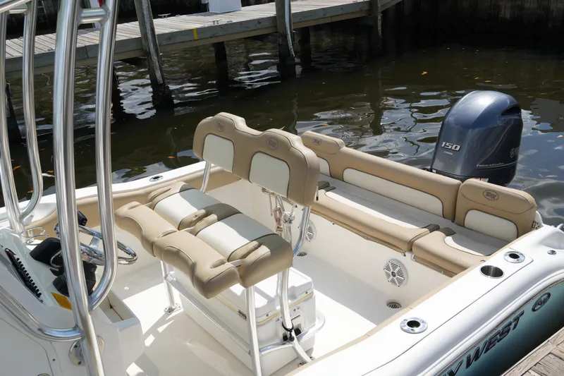 Slide: The Image of 2018 Key West 219 FS boat interior with seating and Yamaha 150 engine. - 18