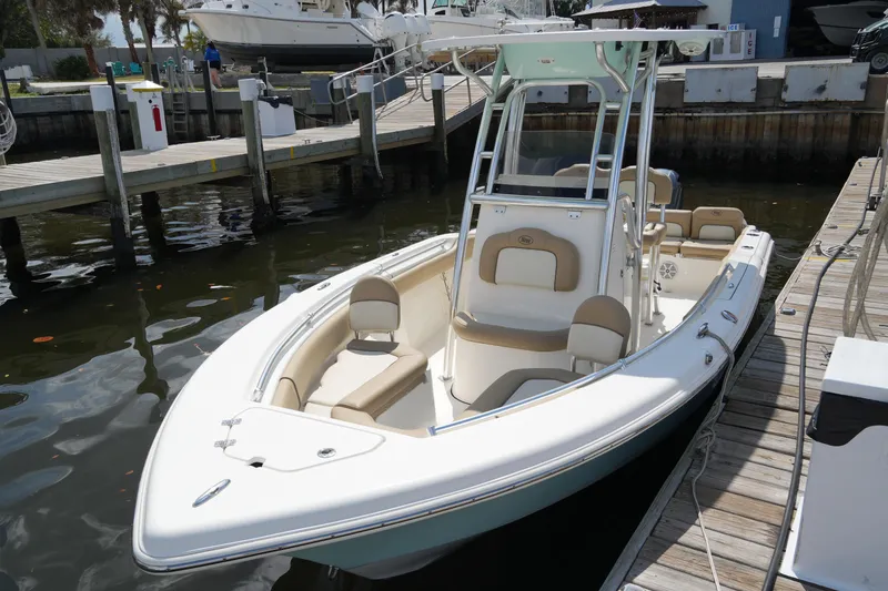 Slide: The Image of 2018 Key West 219 FS boat docked at marina, featuring sleek design and comfortable seating. - 19