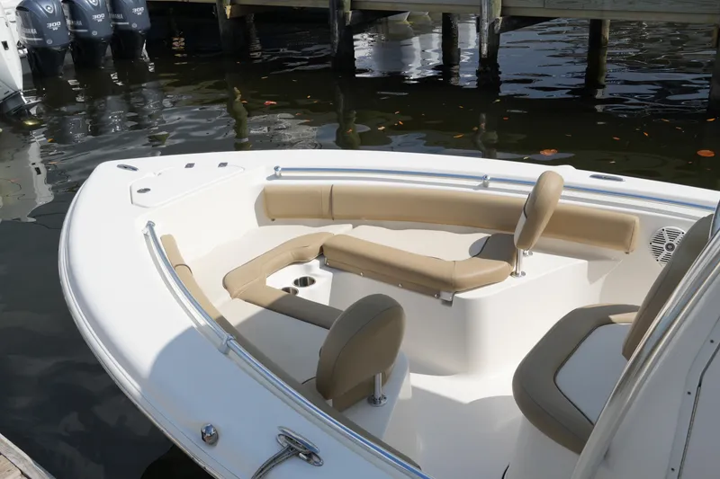 Slide: The Image of 2018 Key West 219 FS boat with beige seating, docked by the water. - 20