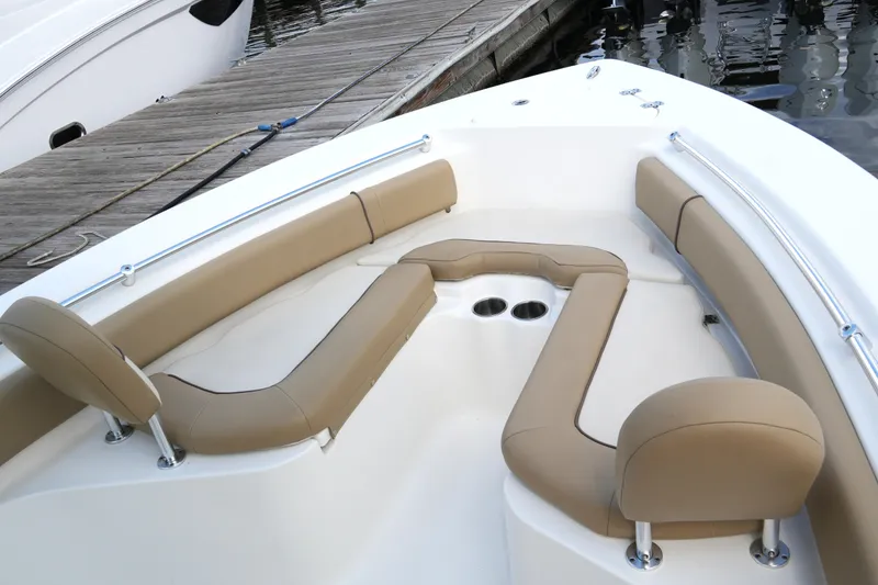 Slide: The Image of 2018 Key West 219 FS boat interior with tan seating and cup holders. - 21
