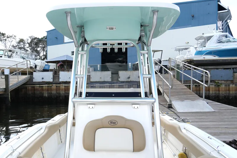 Slide: The Image of 2018 Key West 219 FS boat docked at marina with blue building backdrop. - 22