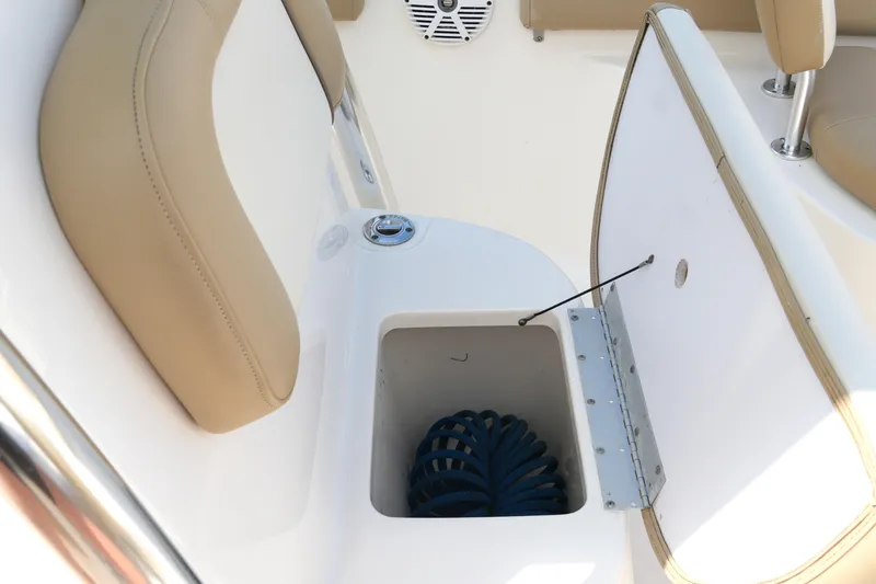 Slide: The Image of 2018 Key West 219 FS boat storage compartment with beige seating and blue coiled rope. - 24