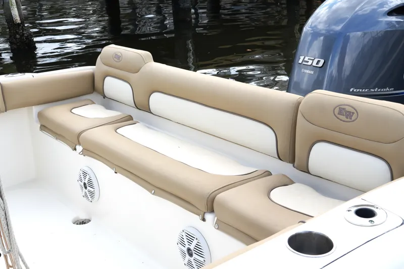 Slide: The Image of 2018 Key West 219 FS boat interior with tan and white seating, Yamaha 150 engine. - 31