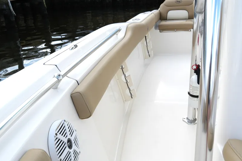 Slide: The Image of 2018 Key West 219 FS boat interior with beige seating and safety equipment. - 33