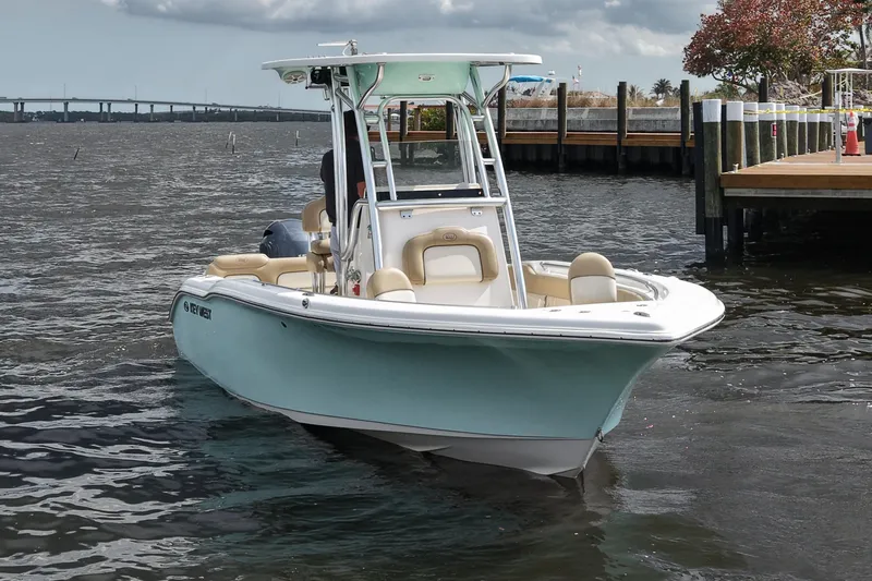 Slide: The Image of 2018 Key West 219 FS boat on water near dock, under cloudy sky. - 4