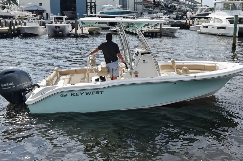Slide: The Image of 2018 Key West 219 FS boat with Yamaha engine docked at marina. - 9