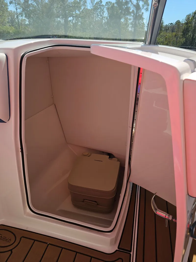 Slide: The Image of Regal 23 OBX 2019 boat cabin with portable toilet. - 14