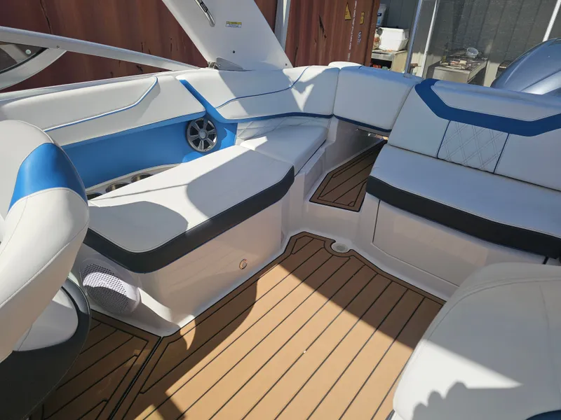 Slide: The Image of Interior of a 2019 Regal 23 OBX boat with blue and white seating. - 18