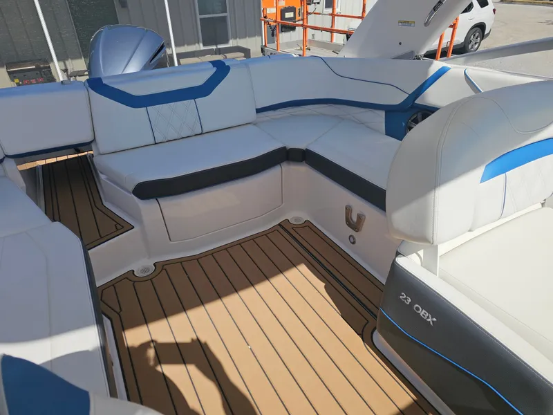 Slide: The Image of Interior of a 2019 Regal 23 OBX boat with blue and white seating. - 19