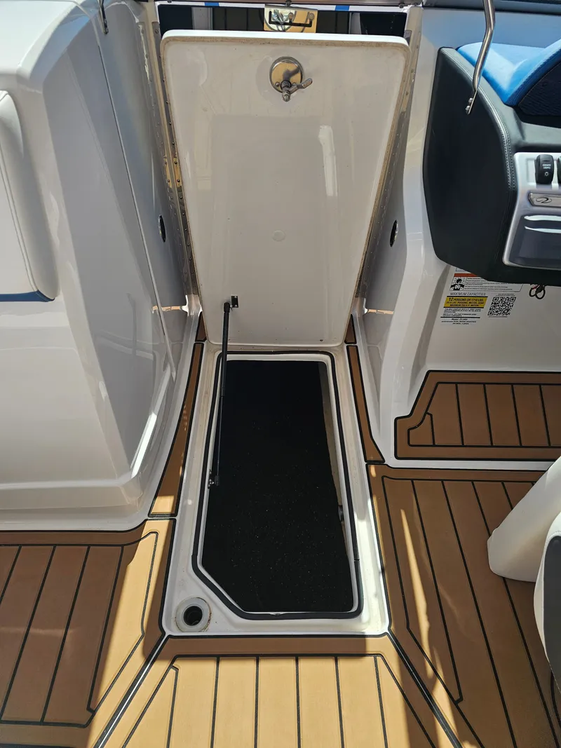 Slide: The Image of Regal 23 OBX 2019 boat with open storage compartment lid. - 22